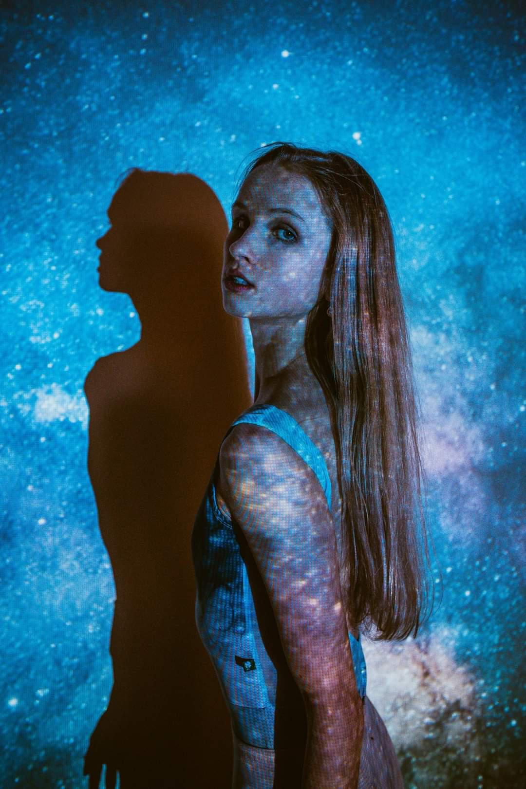 Girl in front of digital art